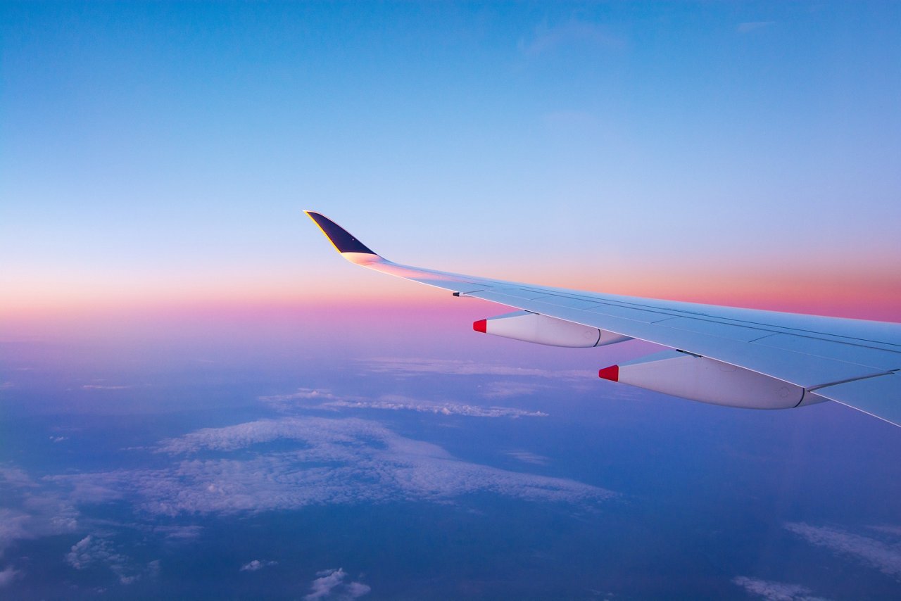 Wing and sunset over sky