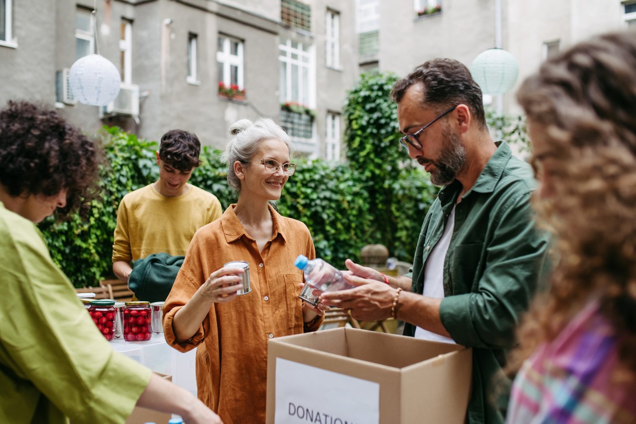 Collection drive. Volunteers collecting food resources and clothes to support people in need, working together.